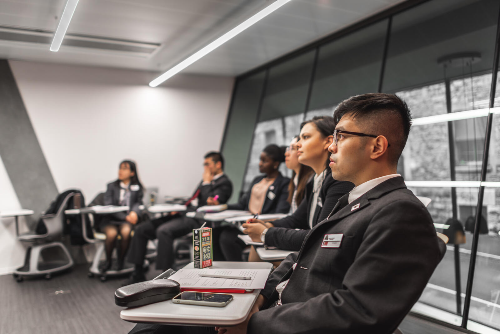 Students at HIM listen to a guest lecture